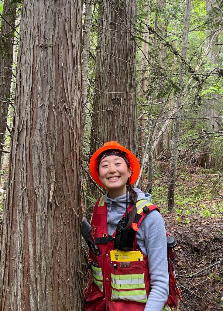 Seo standing near a tree and smiling.