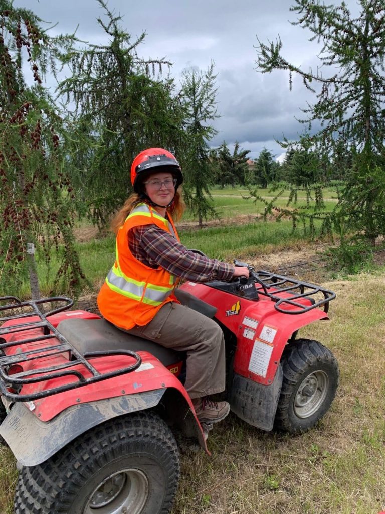 UBC Forestry Co-op student, Abigail Brown, is smiling while riding a vehicle.