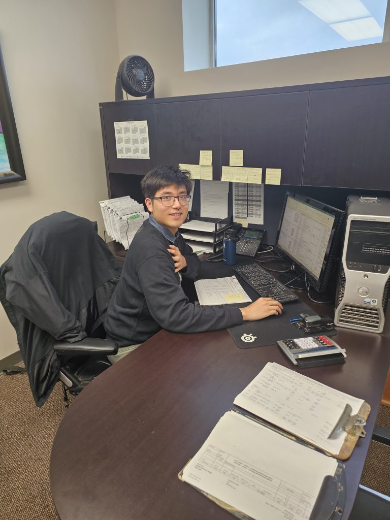 UBC Forestry Co-op Student Ruotong, working at his office desk.