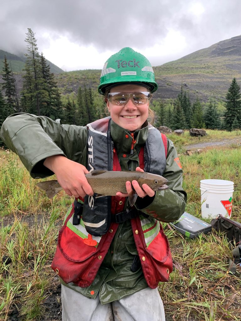 Ainsley Hannah holding a caught fish in the Elk Valley. 